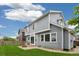 This is an angled view of the backyard of this home, featuring grass, a fence, and a fire pit at 15762 Olmsted Pl, Denver, CO 80239