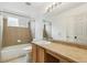 Bathroom with a large mirror and vanity featuring generous counter space at 15762 Olmsted Pl, Denver, CO 80239