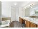 Bright bathroom featuring double sinks, and a tub at 15762 Olmsted Pl, Denver, CO 80239