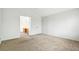 A bright bedroom featuring plush carpeting and an ensuite bathroom at 15762 Olmsted Pl, Denver, CO 80239