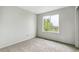 Bright bedroom with neutral carpeting and a large window providing plenty of natural light at 15762 Olmsted Pl, Denver, CO 80239