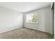 A light-filled bedroom with neutral walls and plush carpet and a large window at 15762 Olmsted Pl, Denver, CO 80239