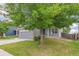 Home exterior features a well-maintained lawn and an attached two-car garage at 15762 Olmsted Pl, Denver, CO 80239