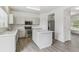 Well lit kitchen area featuring an island, stainless appliances, and white cabinets at 15762 Olmsted Pl, Denver, CO 80239