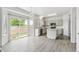 Bright eat-in kitchen featuring an island, stainless appliances, white cabinets and sliding glass doors at 15762 Olmsted Pl, Denver, CO 80239