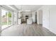 Bright, open kitchen with an island, stainless appliances, white cabinets and hardwood flooring at 15762 Olmsted Pl, Denver, CO 80239
