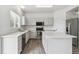 Well lit Kitchen featuring an island, stainless appliances, and white cabinets at 15762 Olmsted Pl, Denver, CO 80239