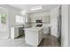 Kitchen featuring an island, stainless appliances, white cabinets, and hardwood flooring at 15762 Olmsted Pl, Denver, CO 80239