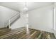 A spacious living room featuring hardwood floors, neutral paint, and access to the staircase at 15762 Olmsted Pl, Denver, CO 80239