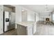 Open-concept kitchen and living room featuring stainless steel appliances, and hardwood floors at 15762 Olmsted Pl, Denver, CO 80239