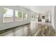Open living room with hardwood floors and lots of light, seamlessly connecting to the kitchen area at 15762 Olmsted Pl, Denver, CO 80239