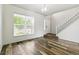 Open concept living room with beautiful laminate floors, neutral paint, and natural light at 15762 Olmsted Pl, Denver, CO 80239