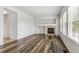 Bright living room features neutral paint, hardwood floors, a fireplace, and natural light at 15762 Olmsted Pl, Denver, CO 80239