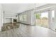 Bright living room with a fireplace, hardwood floors, and natural light from windows and sliding glass doors at 15762 Olmsted Pl, Denver, CO 80239
