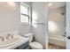 Bathroom with modern sink and vanity next to the toilet and bathtub with white tile at 13440 W 7Th Ave, Lakewood, CO 80401