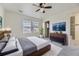 Spacious main bedroom with neutral tones, large windows, ceiling fan and attached bathroom at 4689 Tanner Peak Trl, Brighton, CO 80601