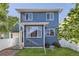 Charming two-story home featuring blue siding, white trim, and a well-manicured lawn at 4689 Tanner Peak Trl, Brighton, CO 80601