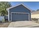 Attached two-car garage with blue door and white trim providing secure parking at 4689 Tanner Peak Trl, Brighton, CO 80601