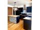 Open kitchen with stainless steel appliances, modern lighting and island at 4689 Tanner Peak Trl, Brighton, CO 80601