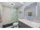 Modern bathroom with subway tile, glass shower, and gray vanity at 2 Adams St # 1401, Denver, CO 80206