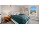 Cozy bedroom featuring a double bed, nightstand, and window with a view at 2 Adams St # 1401, Denver, CO 80206