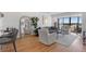 Bright living room with hardwood floors, city views, and modern furniture at 2 Adams St # 1401, Denver, CO 80206