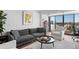 Spacious living room with hardwood floors, large windows, and city views at 2 Adams St # 1401, Denver, CO 80206