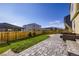 Backyard with a stone patio, lawn, and manicured landscaping at 9099 Sedalia St, Commerce City, CO 80022