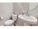Clean and elegant powder room featuring a pedestal sink and modern fixtures at 9099 Sedalia St, Commerce City, CO 80022