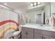 Cozy bathroom with a shower-tub combo and white countertop vanity at 9099 Sedalia St, Commerce City, CO 80022