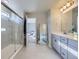 Bright primary bathroom with glass shower, double vanity, and large mirror at 9099 Sedalia St, Commerce City, CO 80022
