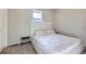 Well-lit bedroom features a large window and a minimalist aesthetic at 9099 Sedalia St, Commerce City, CO 80022