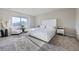 Bright bedroom with large windows, neutral tones, and plush carpet at 9099 Sedalia St, Commerce City, CO 80022