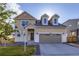 Charming two-story home with a two-car garage and well-maintained front yard with grass and rock at 9099 Sedalia St, Commerce City, CO 80022
