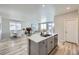 Bright open floor plan with modern kitchen island and stainless steel appliances at 9099 Sedalia St, Commerce City, CO 80022