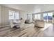Bright living space with dining area, hardwood floors, neutral colors, and stylish furniture at 9099 Sedalia St, Commerce City, CO 80022
