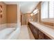 Luxurious bathroom with a soaking tub, double vanity, and elegant tilework at 7132 S Irvington Ct, Aurora, CO 80016