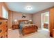 Bedroom with window and dresser, comfortable bed, side tables, and wooden furnishings at 7132 S Irvington Ct, Aurora, CO 80016