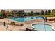 Large community pool with dedicated splash pad and hot tub at 7132 S Irvington Ct, Aurora, CO 80016