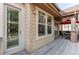 A view of the covered patio, which has comfortable furniture and a red umbrella for shade at 7132 S Irvington Ct, Aurora, CO 80016