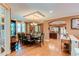 Elegant dining room with hardwood floors, chandelier, and view into the kitchen and living area at 7132 S Irvington Ct, Aurora, CO 80016