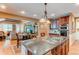 Open concept kitchen featuring a center island with cooktop and stainless steel appliances at 7132 S Irvington Ct, Aurora, CO 80016