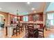 Spacious kitchen featuring wooden cabinets, granite countertops, a center island and eat-in breakfast table at 7132 S Irvington Ct, Aurora, CO 80016
