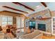 Inviting living room with a stone fireplace, built-in bookshelves, and hardwood floors at 7132 S Irvington Ct, Aurora, CO 80016