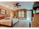Spacious main bedroom with a ceiling fan, a sitting area, and access to a private balcony at 7132 S Irvington Ct, Aurora, CO 80016