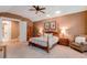 Comfortable main bedroom with a ceiling fan, lamps, and a cozy chair at 7132 S Irvington Ct, Aurora, CO 80016