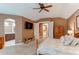 Beautiful main bedroom with a ceiling fan, hardwood floors, and ensuite bathroom entrance at 7132 S Irvington Ct, Aurora, CO 80016