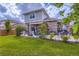 A well-maintained backyard offers a patio, mature trees, and a tranquil outdoor space at 24748 E Layton Pl, Aurora, CO 80016