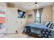 Cozy bedroom featuring a large window, ceiling fan, and a doorway leading to another room at 24748 E Layton Pl, Aurora, CO 80016
