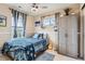 Inviting bedroom with warm walls, two windows, and a ceiling fan at 24748 E Layton Pl, Aurora, CO 80016